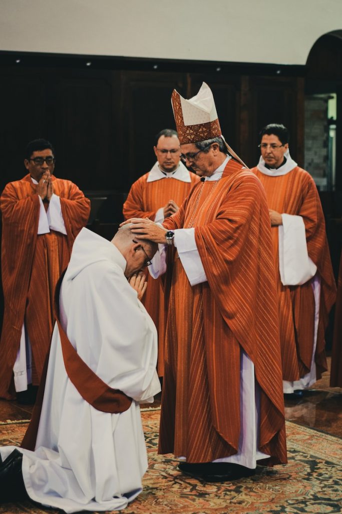 priest in brown and white robe